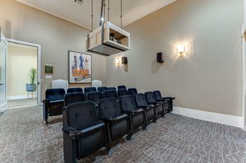A row of black chairs are lined up in a room.